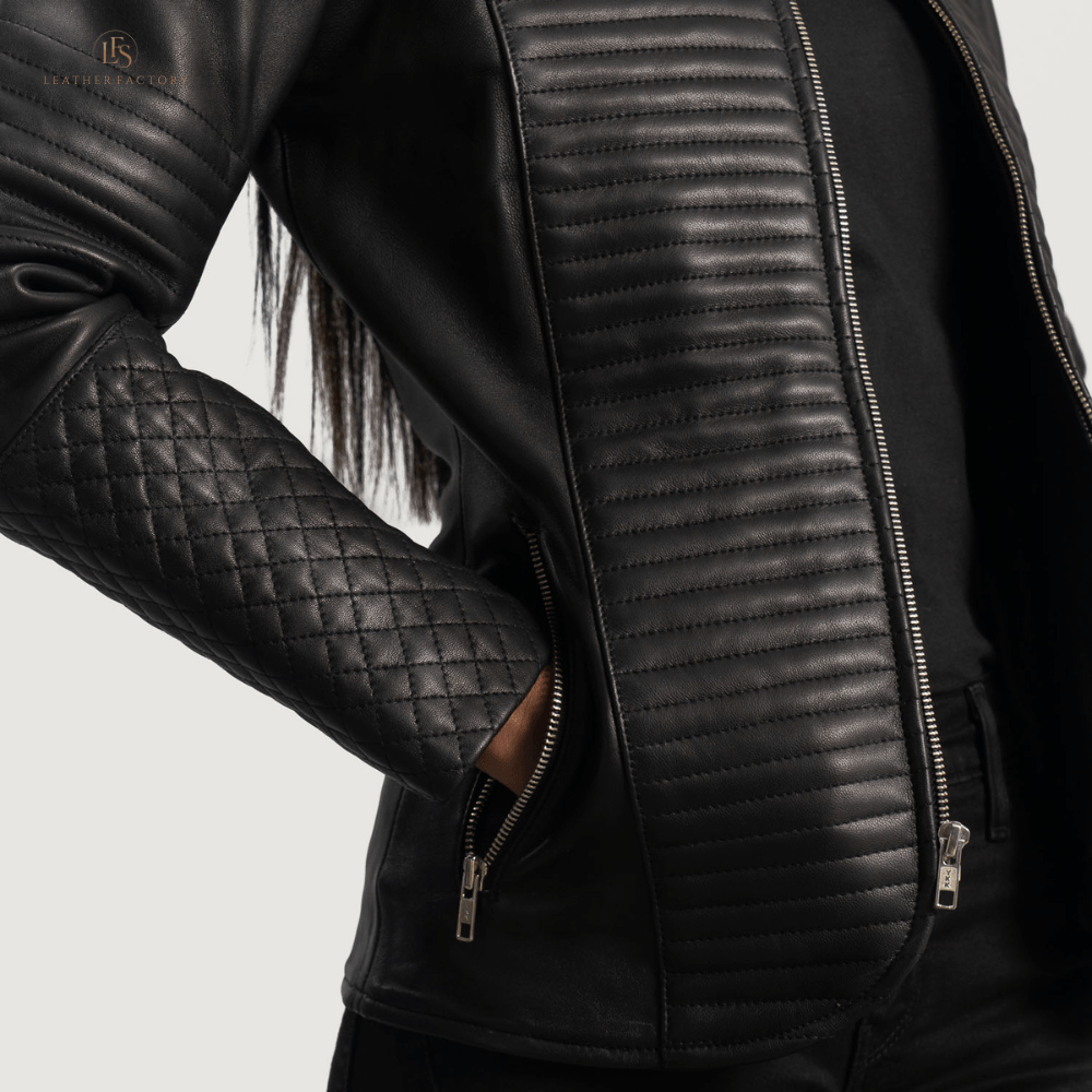 Woman wearing a premium black cowhide leather biker jacket with notch collar, zippered cuffs, removable belt, shoulder epaulettes, and multiple pockets