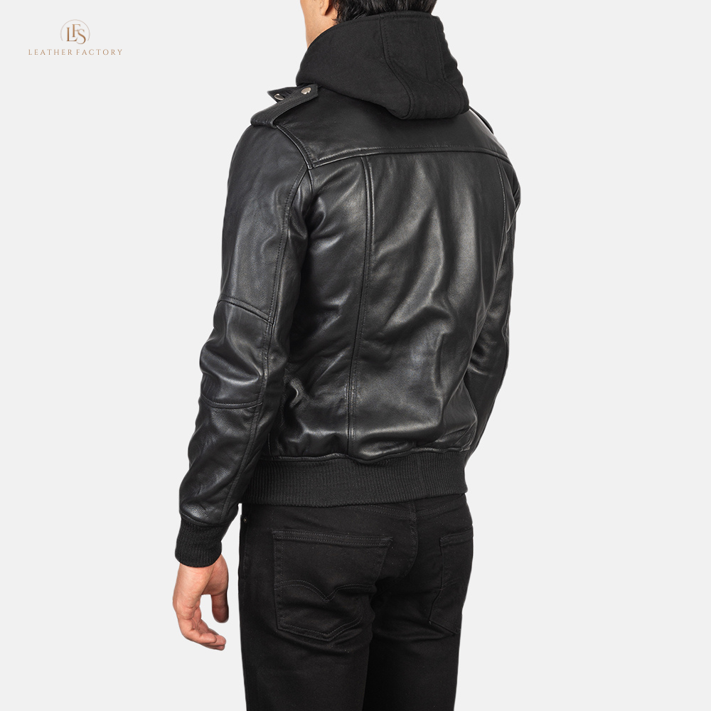 Man wearing a premium black leather bomber jacket with a removable hood and rib knit cuffs