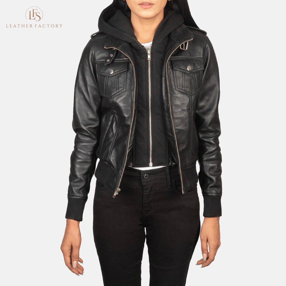 Woman wearing the Roslyn black sheepskin hooded leather bomber jacket featuring a high neck with belt, shoulder epaulettes, and a removable fabric hood.