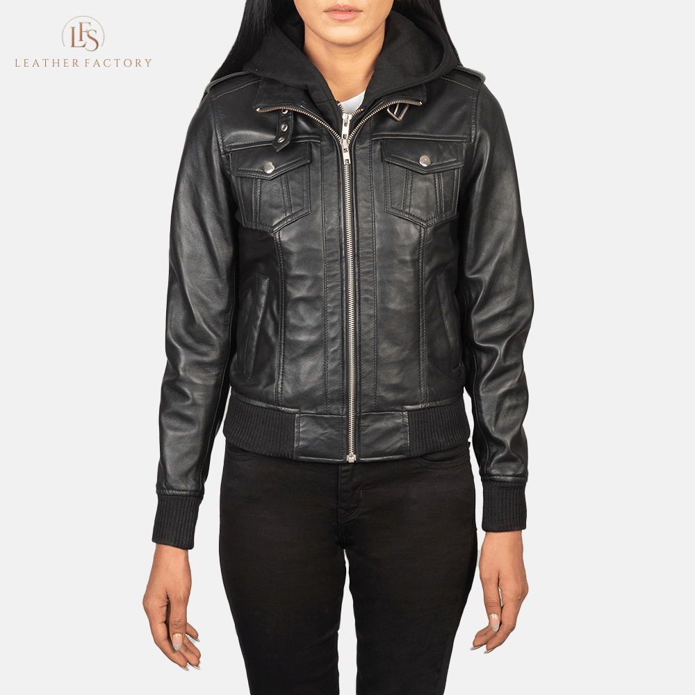 Woman wearing the Roslyn black sheepskin hooded leather bomber jacket featuring a high neck with belt, shoulder epaulettes, and a removable fabric hood.